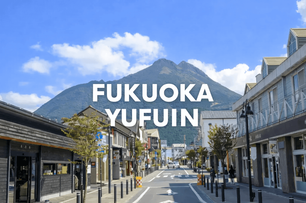 kyushu road trip เส้นทาง Fukuoka ไป Yufuin ถนนในเมืองยูฟุอินเงียบสงบ รายล้อมด้วยร้านค้าและอาคารสไตล์ญี่ปุ่น โดยมีภูเขา Mt. Yufu เป็นฉากหลัง พร้อมตัวอักษร “FUKUOKA YUFUIN” อยู่กลางภาพ